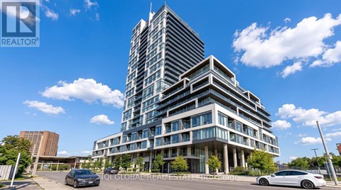 A modern multi-story building with a glass facade is the main focus of the image.