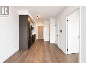 A long hallway with white walls and wood floors.