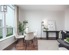 A dining room with a white table and chairs.