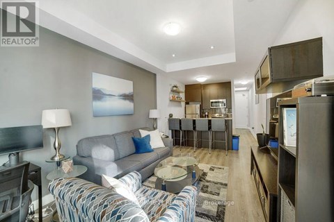 A living room with a grey couch and a coffee table.