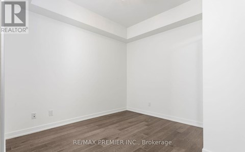 A room with a wooden floor and white walls.