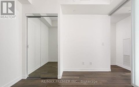A white room with a doorway leading to another room.