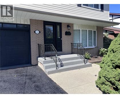 A house with a black door and a sign that says REALTOR.