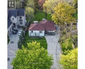 A house with a sign that says "REALTOR" on the left side.