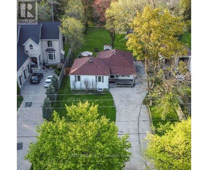 A house with a sign that says "REALTOR" on the left side.