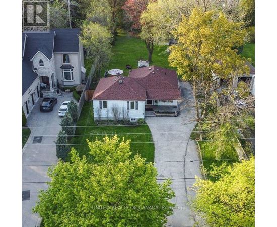 A house with a sign that says "REALTOR" on the left side.
