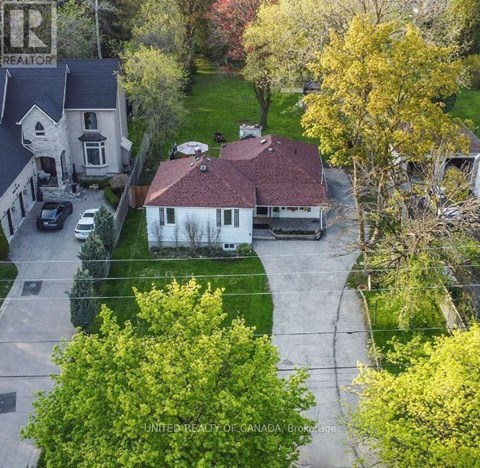 A house with a sign that says "REALTOR" on the left side.