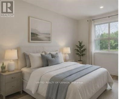 A bedroom with a bed, nightstands, and a framed picture on the wall.
