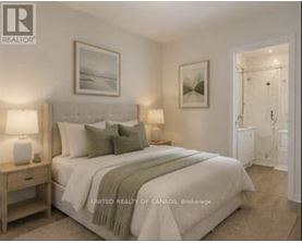 A bedroom with a large bed and a painting on the wall.