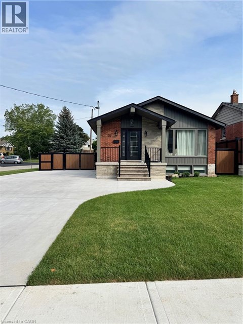 A house with a brown brick exterior and a black door is shown.