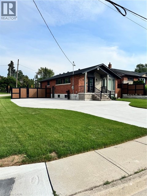 A house with a green lawn in front.