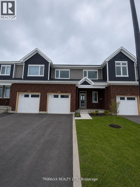A house with a grey roof and a brick facade is for sale.