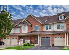 A house with a red brick facade and a white garage door is for sale.