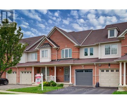 A house with a red brick facade and a white garage door is for sale.