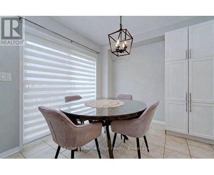 A dining room with a table and chairs.