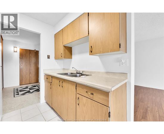 A kitchen with wooden cabinets and a sink.