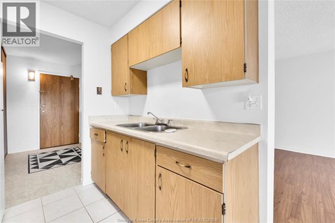 A kitchen with wooden cabinets and a sink.