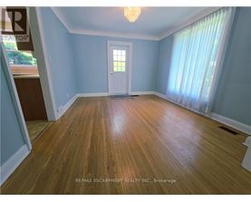 A room with wooden flooring and a white door.