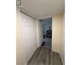 A hallway with a white door and a black and white checkered floor.