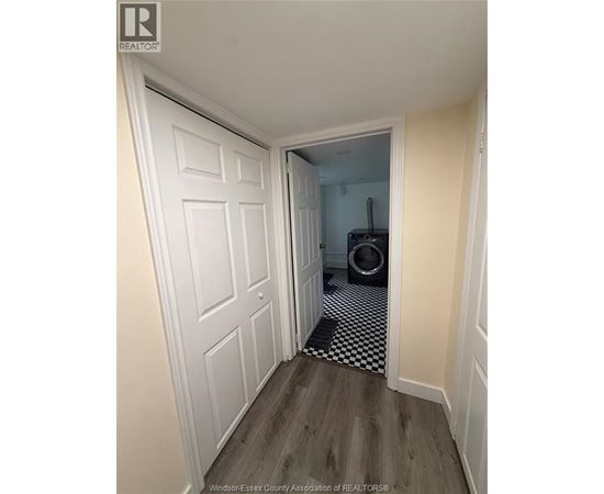 A hallway with a white door and a black and white checkered floor.