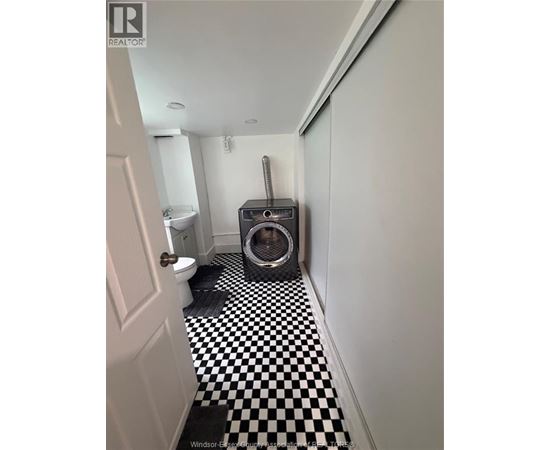 A black and white checkered floor in a bathroom.