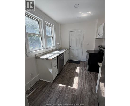 A kitchen with a sink under a window.