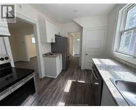 A kitchen with a stove, oven, and sink.