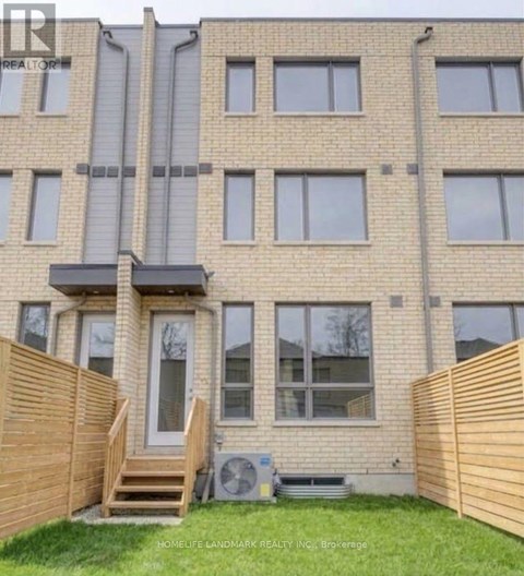 A building with a brown fence in front of it.