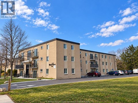 A large apartment building with the word "Mountain" on the front.