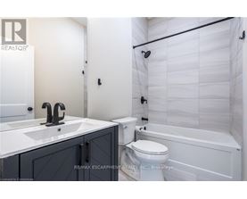 A white bathroom with a sink, toilet and bathtub.