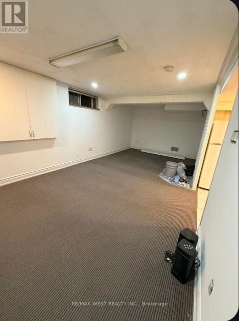 A room with a carpeted floor and a window.
