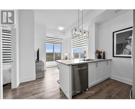 A modern kitchen with white cabinets and a large island.