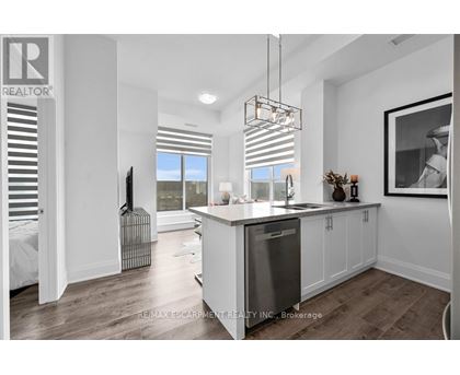 A modern kitchen with white cabinets and a large island.