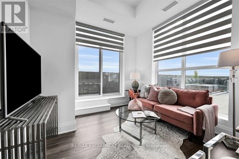 A living room with a red couch and a television.