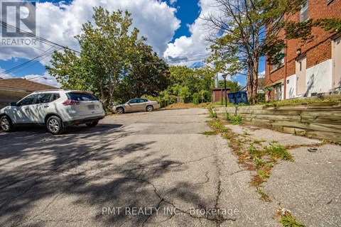 A parking lot with a car and a building in the background.