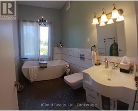 A bathroom with a tub, toilet, and sink.