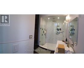 A bathroom with a shower and a sink.