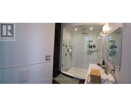 A bathroom with a shower and a sink.