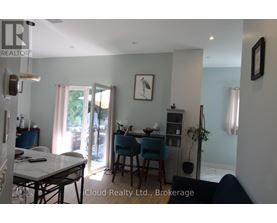 A dining room with a table and chairs.