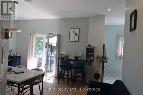 A dining room with a table and chairs.