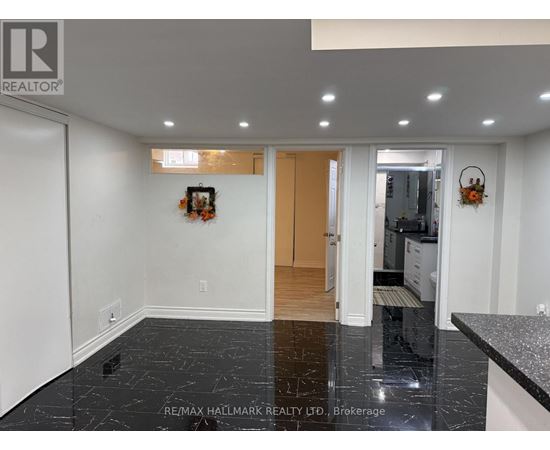 A black marble floor in a white room with a wooden door.