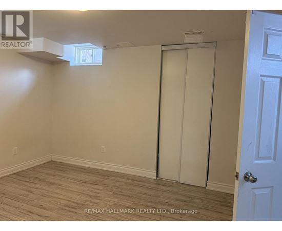 A room with a white door and a window on the ceiling.
