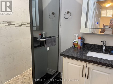 A bathroom with a sink, mirror, and toiletries.