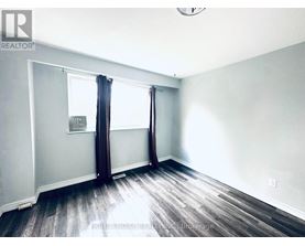 A room with a window and a sign on the wall.