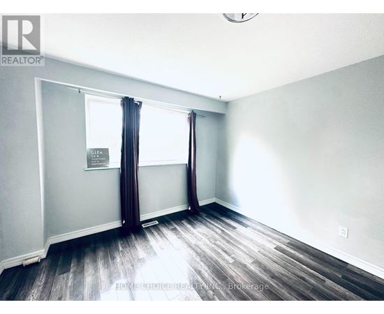 A room with a window and a sign on the wall.