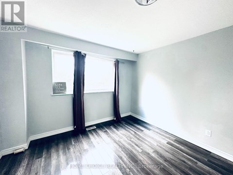 A room with a window and a sign on the wall.