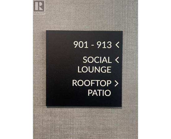 A sign with directions to the social lounge and rooftop patio.
