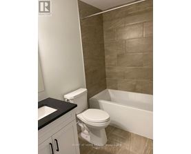 A bathroom with a toilet, sink, and bathtub.
