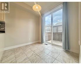 A room with a sliding glass door leading to a balcony.