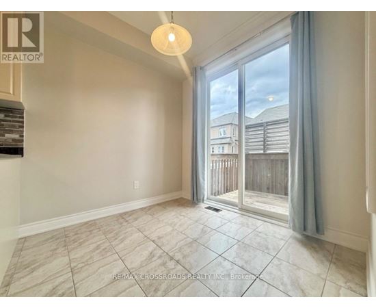 A room with a sliding glass door leading to a balcony.